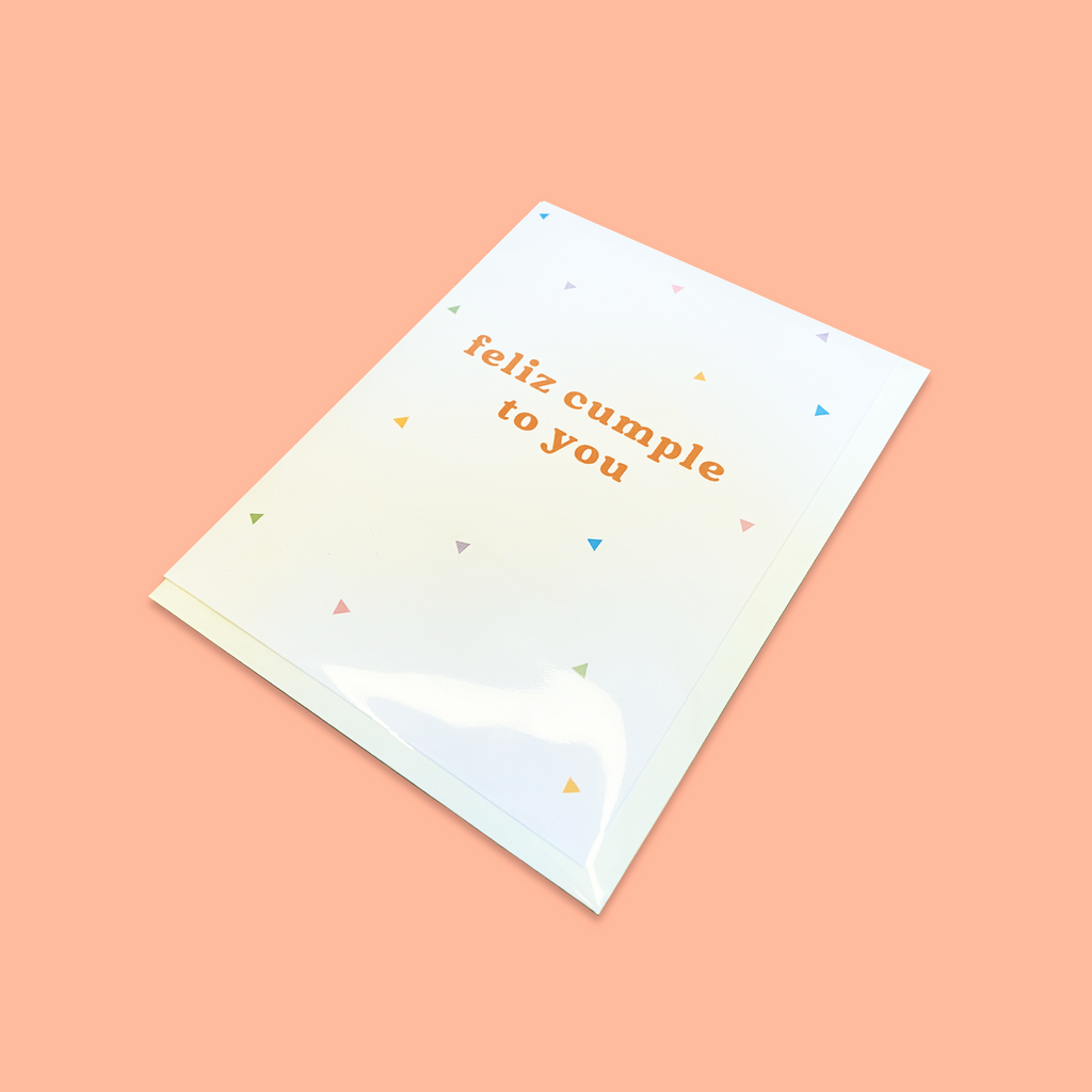 "Feliz Cumple To You" greeting card packaged with envelope in a biodegradable cellophane sleeve.