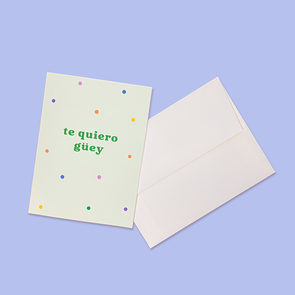"Te Quiero Güey" greeting card next to creme colored envelope.