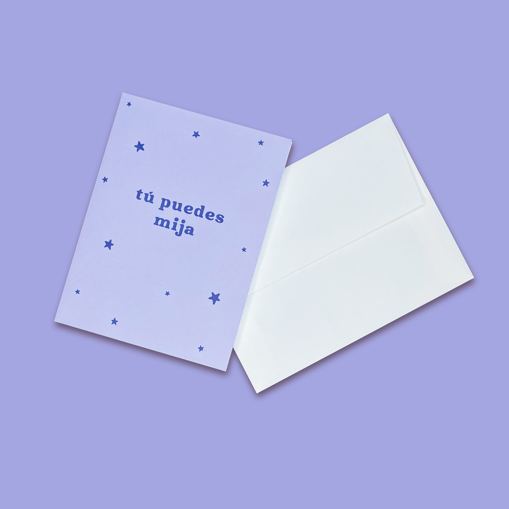 "Tu Puedes Mija" greeting card next to creme colored envelope.