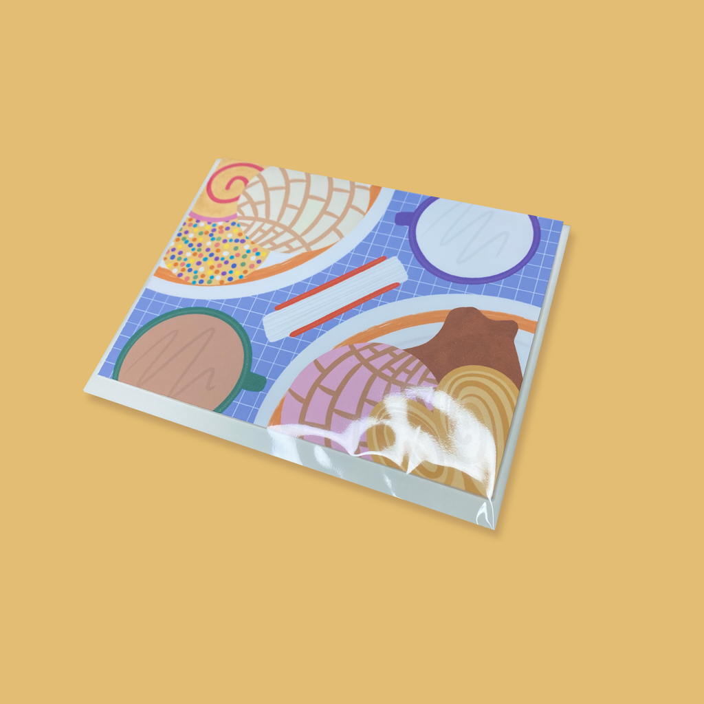 "En La Mesa Pan Dulce" greeting card packaged with envelope in a biodegradable cellophane sleeve.