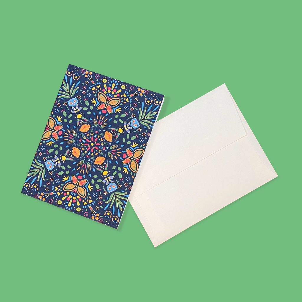 "Tierra Verde" greeting card next to creme colored envelope.